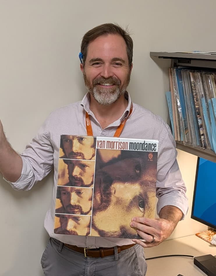 Tyler Jorgensen holding Van Morrison Moondance vinyl record